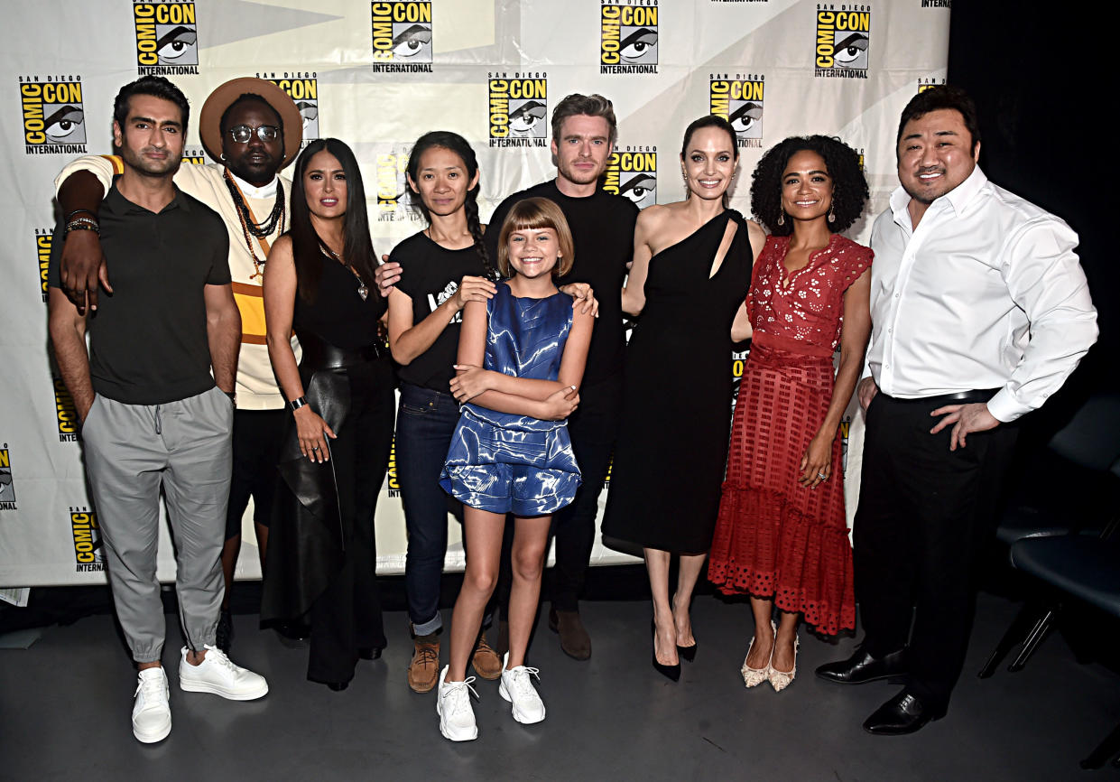 SAN DIEGO, CALIFORNIA - JULY 20: (L-R) Kumail Nanjiani, Brian Tyree Henry, Salma Hayek, Director Chloe Zhao, Lia McHugh, Richard Madden, Angelina Jolie, Lauren Ridloff and Don Lee of Marvel Studios' 'The Eternals' at the San Diego Comic-Con International 2019 Marvel Studios Panel in Hall H on July 20, 2019 in San Diego, California. (Photo by Alberto E. Rodriguez/Getty Images for Disney)