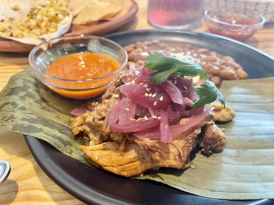 Malinche serves its cochinita pibil on banana leaves with a side of warm tortillas.