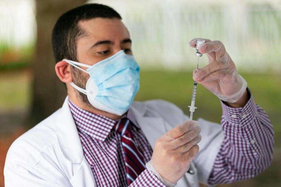 Dr. Daniel Carvajal, 34, draws a syringe with the Pfizer-BioNTech COVID-19 vaccine at The Palace Renaissance & Royale, an assisted living facility in Kendall, on Wednesday, January 13, 2021. Vaccines were available Wednesday for The Palace residents and staff.