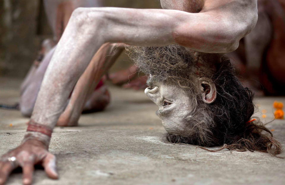 <p>An Indian Sadhu or Hindu holy man performs Yoga to mark International Yoga Day at Kamakhya temple in Gauhati, India, Wednesday, June 21, 2017. (Photo: Anupam Nath/AP) </p>