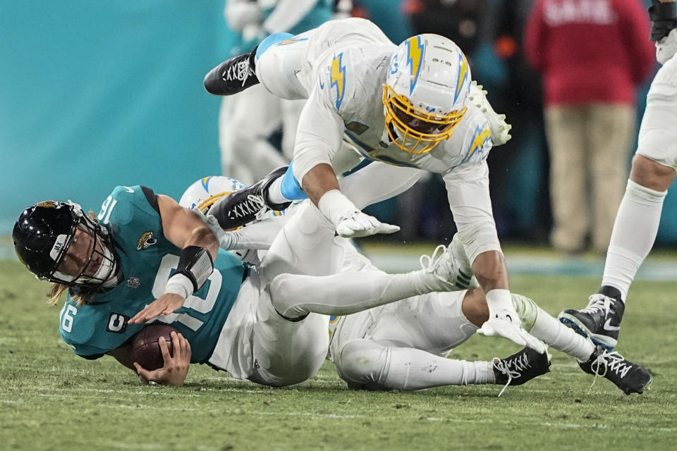 Jacksonville Jaguars quarterback Trevor Lawrence (16) is sacked against the Los Angeles Chargers during the second half of an NFL wild-card football game, Saturday, Jan. 14, 2023, in Jacksonville, Fla. The Los Angeles Chargers were called for a penalty voiding the sack. (AP Photo/Chris Carlson)