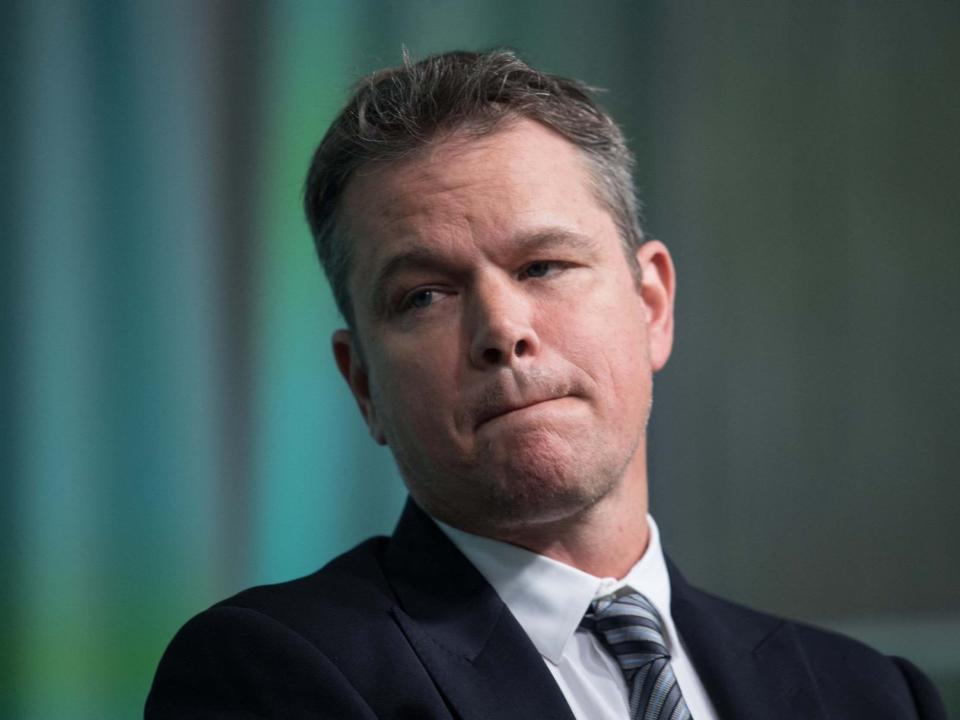 Matt Damon onstage at event making disappointed facial expression