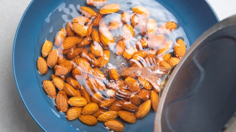 pouring boiling water on almonds