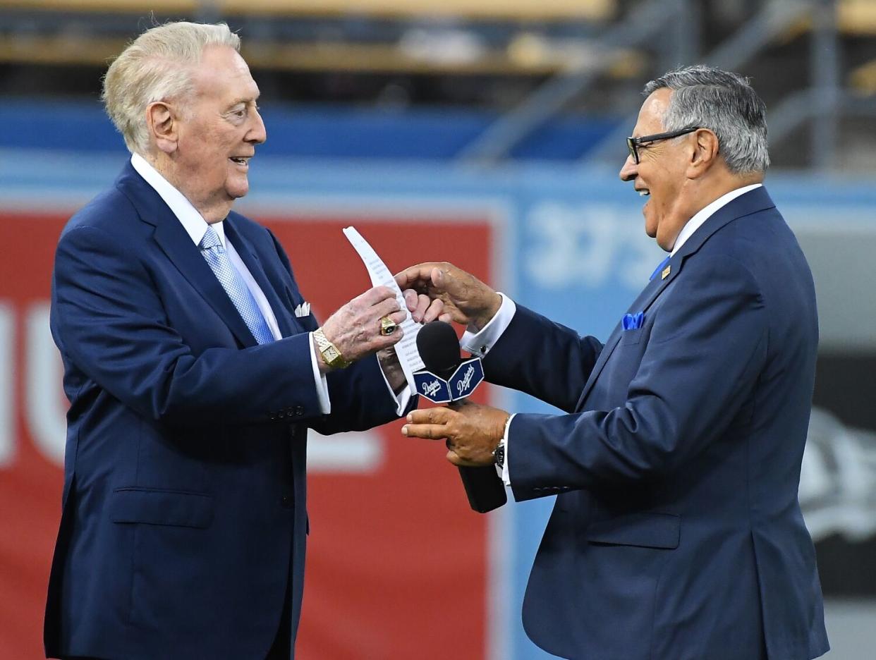 Dodgers broadcaster Vin Scully, left, jokes with Spanish-language broadcaster Jaime Jarrín.