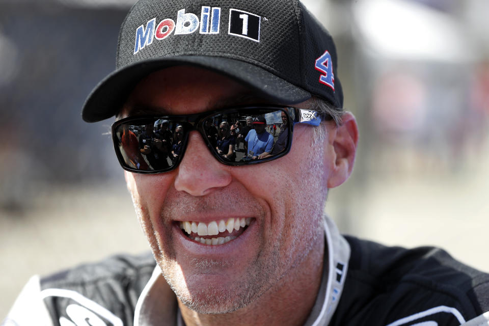 Kevin Harvick smiles during practice for a NASCAR Cup Series auto race at Michigan International Speedway in Brooklyn, Mich., Saturday, Aug. 10, 2019. (AP Photo/Paul Sancya)