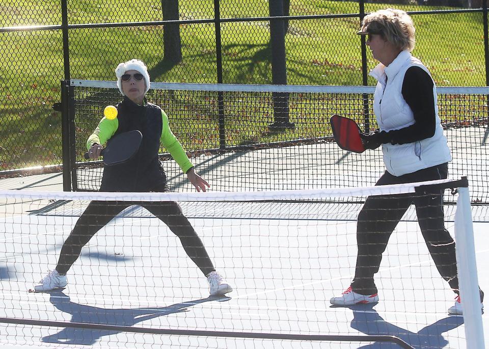 Susan Teat, left, and Joy Dawson, both of New Philadelphia, Ohio, enjoyed a game of pickle ball on the tennis courts at Tuscora Park.