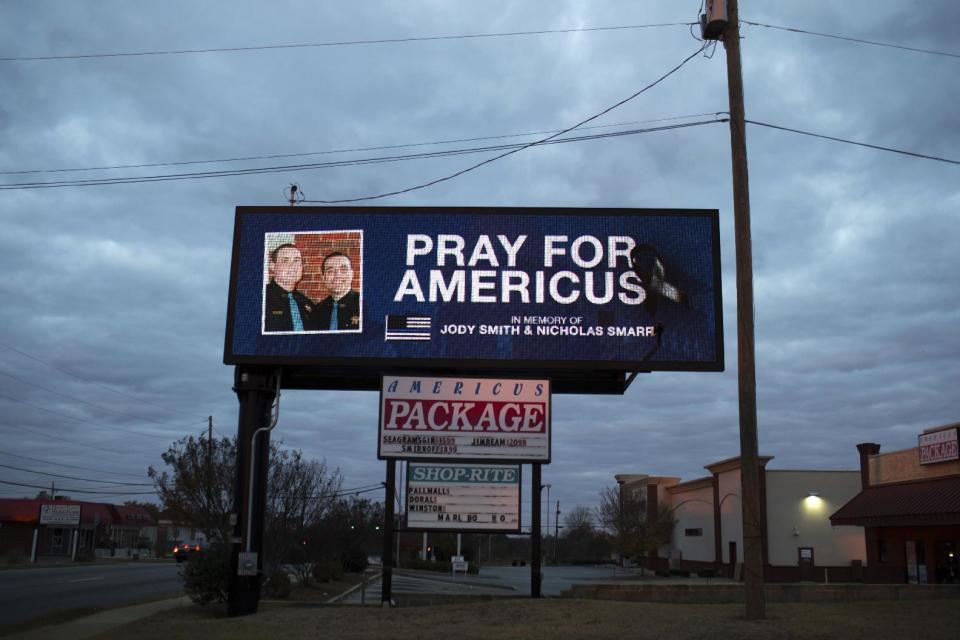 A message in memory Georgia Southwestern campus police officer Jody Smith and Americus Police Officer Nicholas Smarr is displayed on a billboard, Sunday, Dec. 11, 2016, in Americus, Ga. Smarr, died after responding to a domestic disturbance call in a Wednesday morning attack. His lifelong friend, university campus Officer Jody Smith, was critically wounded after arriving on the scene as backup to Smarr, and later died from his injuries Thursday. (AP Photo/Branden Camp)