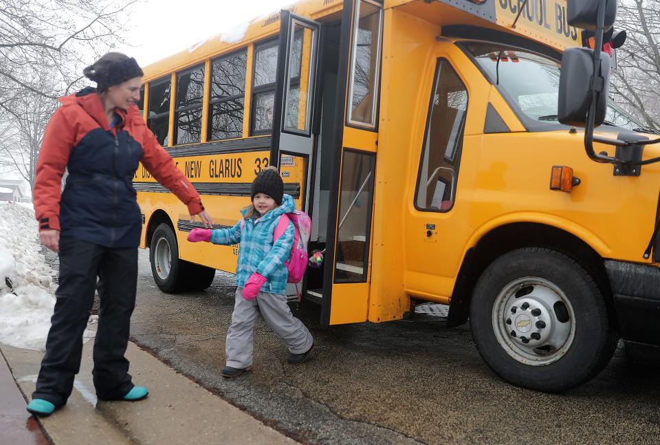 Corrine Hendrickson helps Aurora Funseth, 4, off the bus after her 4K class on Jan. 25  in New Glarus. Hendrickson's program is a home-based family child care center, Corrine's Little Explorers. Hendrickson recently testified in support of a bill that seeks to alter the state's public 4K structure to require school districts to contract with program's like Hendrickson's to offer public 4K. As of now, because the district and Hendrickson don't have a contract, she cannot offer free 4K instruction at her program.