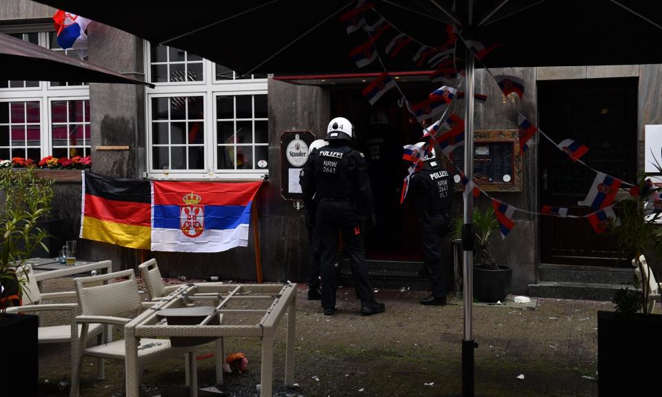 <span>Police outside the restaurant in Gelsenkirchen where <a class="link " href="https://sports.yahoo.com/soccer/teams/england/" data-i13n="sec:content-canvas;subsec:anchor_text;elm:context_link" data-ylk="slk:England;sec:content-canvas;subsec:anchor_text;elm:context_link;itc:0">England</a> and <a class="link " href="https://sports.yahoo.com/soccer/teams/serbia/" data-i13n="sec:content-canvas;subsec:anchor_text;elm:context_link" data-ylk="slk:Serbia;sec:content-canvas;subsec:anchor_text;elm:context_link;itc:0">Serbia</a> fans clashed.</span><span>Photograph: Sebastian Frej/MB Media/Getty Images</span>