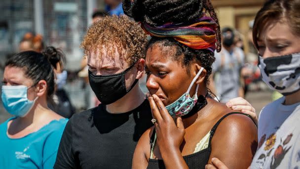 PHOTO: A mourner cries as she visits a makeshift memorial for George Floyd on the corner of Chicago Avenue and East 38th Street, May 31, 2020, in Minneapolis. (John Minchillo/AP)