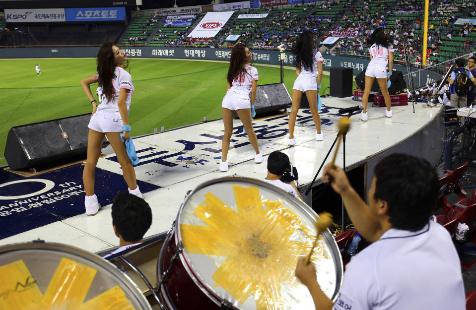 FILE - Cheerleaders of the South Korean baseball team Doosan Bears dance to the drumbeat and music at Jamsil Stadium in Seoul, South Korea, on Sept. 6, 2012. (AP Photo/Hye Soo Nah, File)