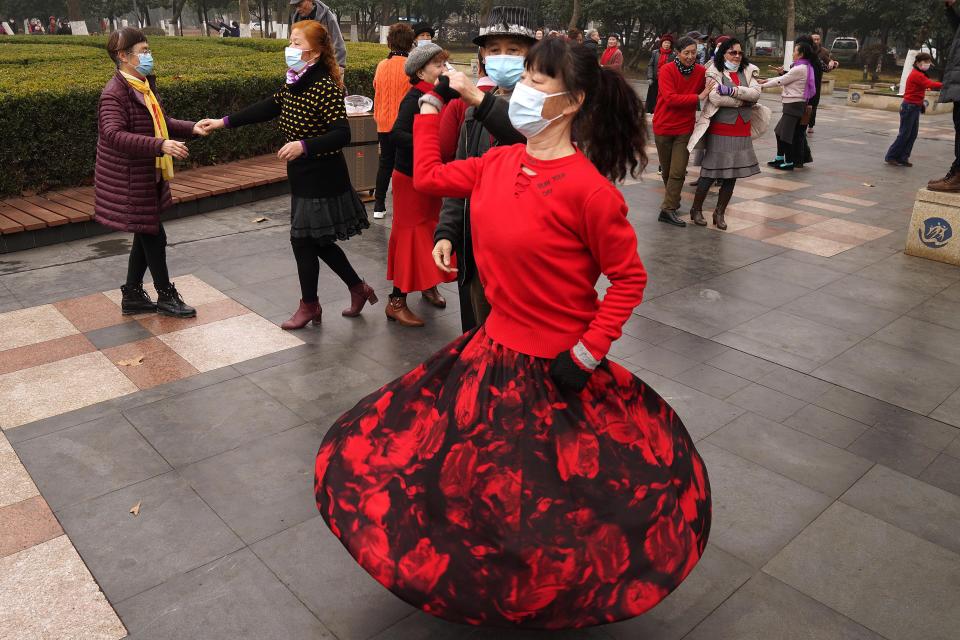 Residents wear masks as they dance at a park in Wuhan in central China's Hubei Province on Saturday, Jan. 23, 2021. A year after it was locked down to contain the spread of coronavirus, the central Chinese city of Wuhan has largely returned to normal, even as China continues to battle outbreaks elsewhere in the country. (AP Photo/Ng Han Guan)