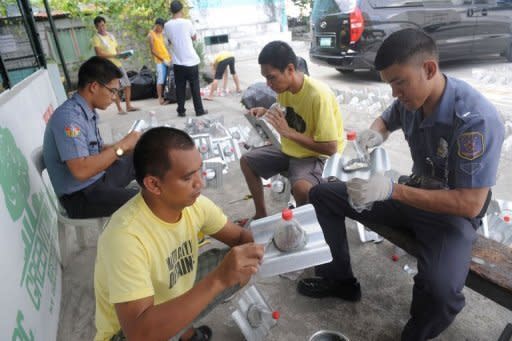 Inmates and jail guards manufacture solar light bottles at a jail in Manila. Illac Diaz said another 100,000 would be installed in Cebu in December, putting the project on track to meet or exceed its goals of helping one million people over 12 months