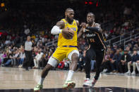 Los Angeles Lakers forward LeBron James drives to the basket against Atlanta Hawks forward AJ Griffin during the first half of an NBA basketball game Friday, Dec. 30, 2022, in Atlanta. (AP Photo/Hakim Wright Sr.)