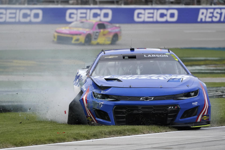 Kyle Larson (5) limps into pit row after crashing in turn number four during the during the NASCAR All-Star auto race at Texas Motor Speedway in Fort Worth, Texas, Sunday, May 22, 2022. (AP Photo/Larry Papke)