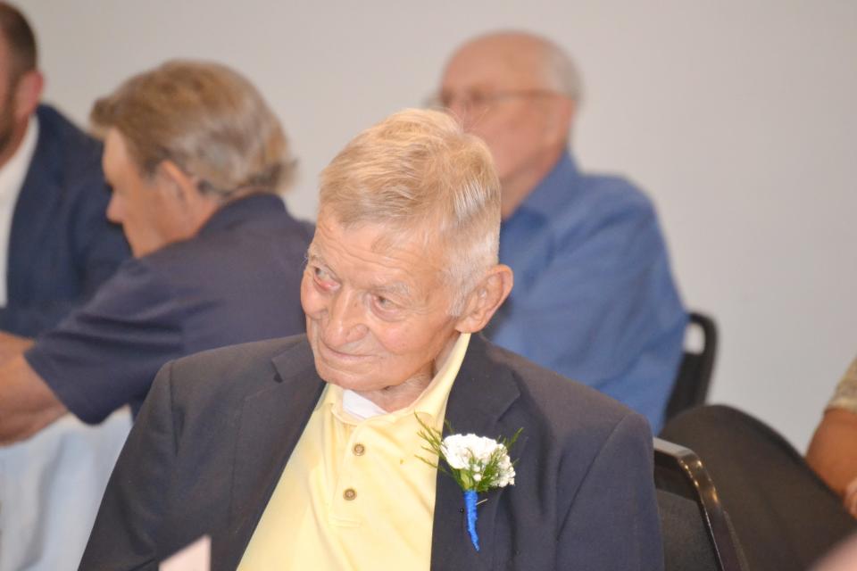 Coach Jim Lanagan listens as his Hall of Fame bio is read.