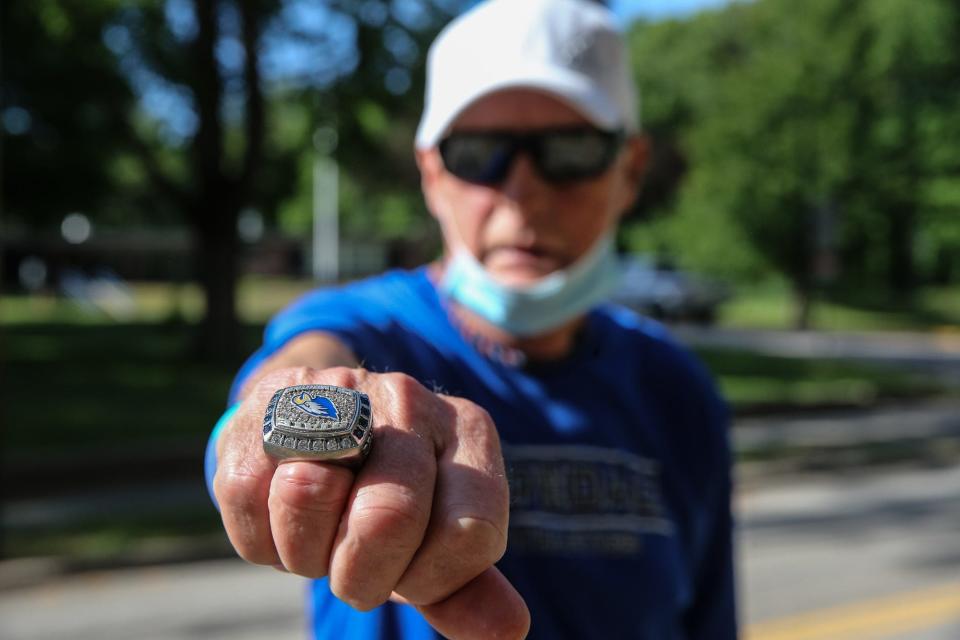 In 2020, Hopedale running coach Joe Drugan showed off a Hopedale cross country championship ring before he ran the "Crush Corona" 5K starting at Hopedale Memorial Elementary School.