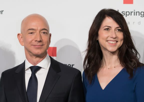 MacKenzie Scott (right), ex-wife of Amazon founder Jeff Bezos (left), has committed to giving away a portion of her nearly $33 billion fortune, often choosing community-based education groups as beneficiaries. (Jörg Carstensen/Getty Images)