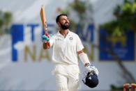 Cricket - Sri Lanka v India - First Test Match - Galle, Sri Lanka - July 26, 2017 - India's cricketer Cheteshwar Pujara celebrates his century. REUTERS/Dinuka Liyanawatte