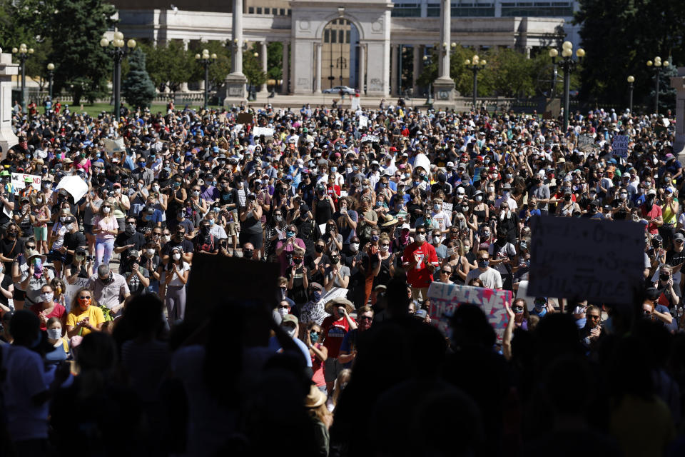 Demonstrators crowd into Civic Center Park during a rally calling for more oversight of the police Sunday, June 7, 2020, in Denver. Demonstrators marched from the park, which is in the heart of downtown, east along Colfax Avenue to City Park after the rally. (AP Photo/David Zalubowski)