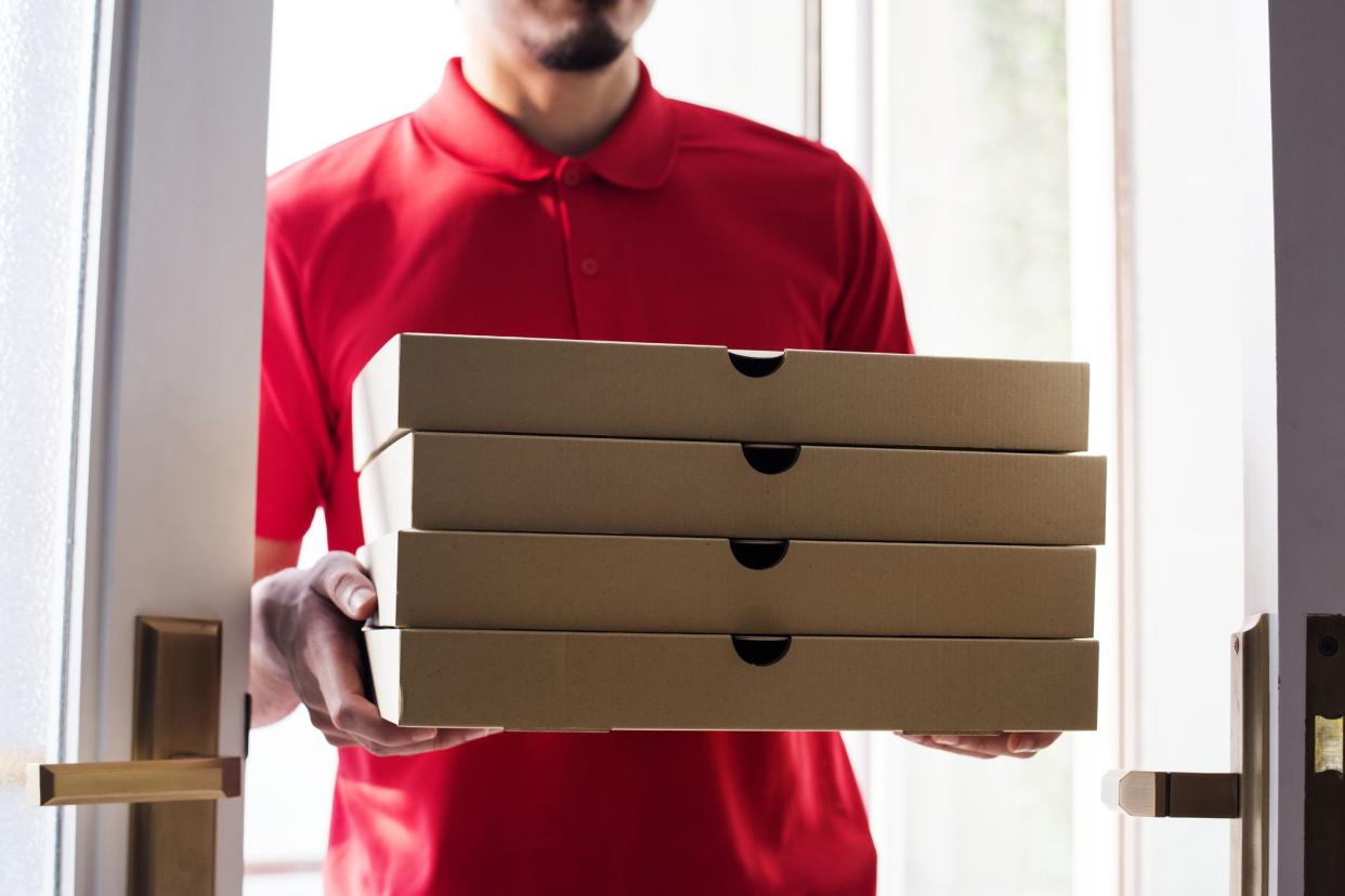 Man delivering pizza to customer