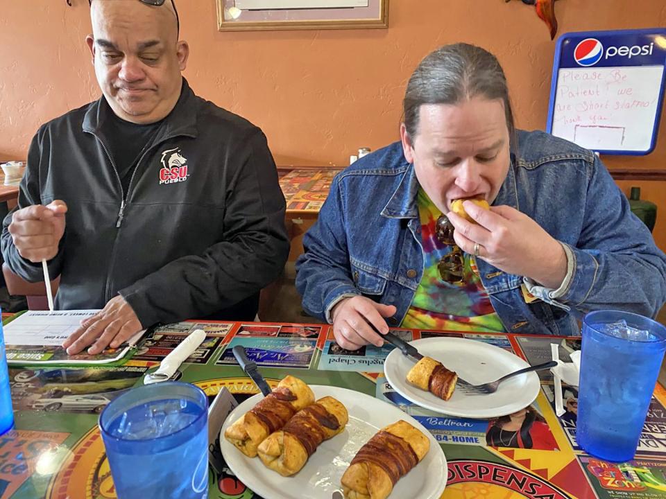 Judges Jerry Carter (left) and John Jakeman sample at Romero's Cafe, where the winning appetizer, Chile Cones, was served.