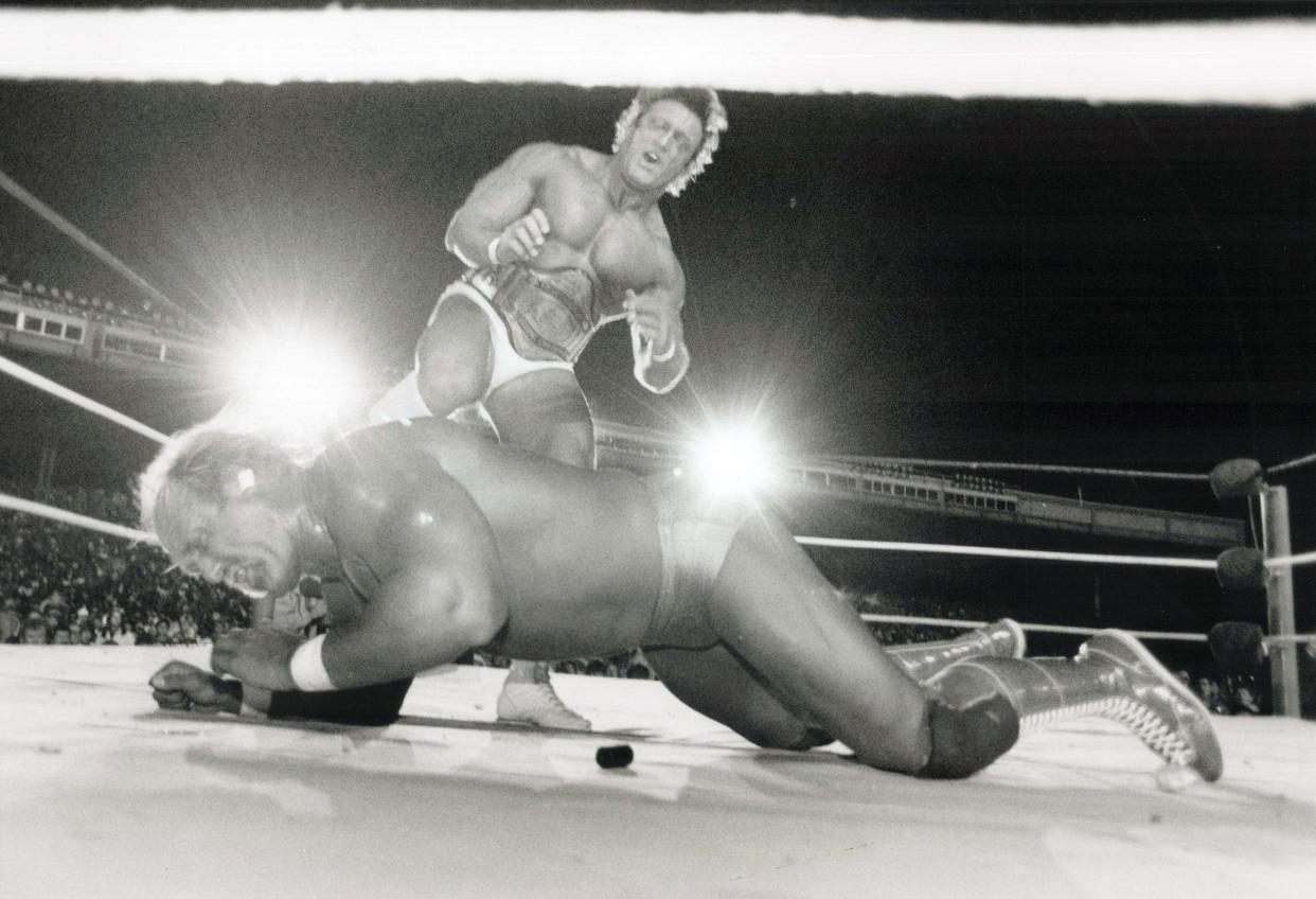 Hulk Hogan grimaces as he takes a well-placed boot in the ribs from Paul (Pretty Boy) Orndorff during their grudge match at the Ex in Toronto in 1986. 