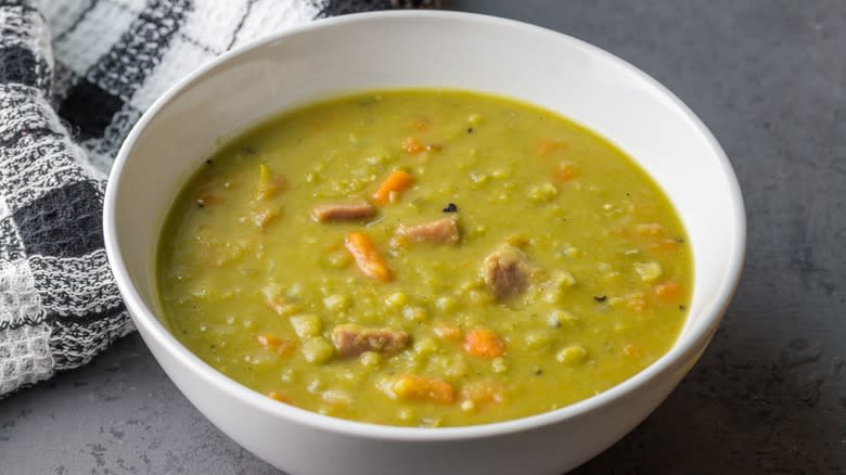Yellow pea soup in white bowl 