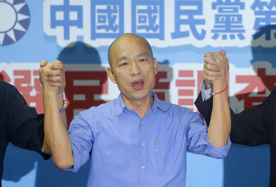 FILE - In this  July 15, 2019, file photo, Kaohsiung city mayor Han Kuo-yu and presidential candidate raises hands for the opposition of the Nationalist Party (KMT) for the upcoming presidential election in Taipei, Taiwan. Han has chosen a former Google executive and former state premier Cheng San-cheng as his running mate. Cheng received master’s and doctoral degrees from Stanford and Cornell universities in the United States. (AP Photo/Chiang Ying-ying, File)