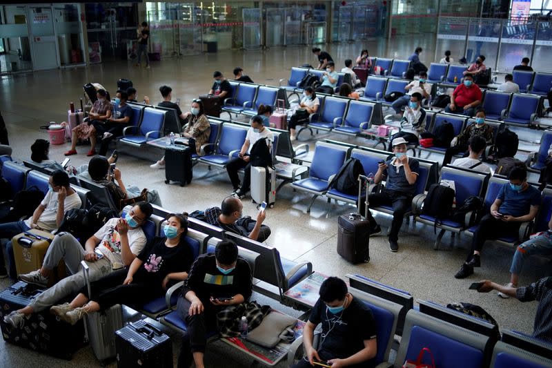 People wearing face masks are seen at Wuhan Railway Station, in Wuhan