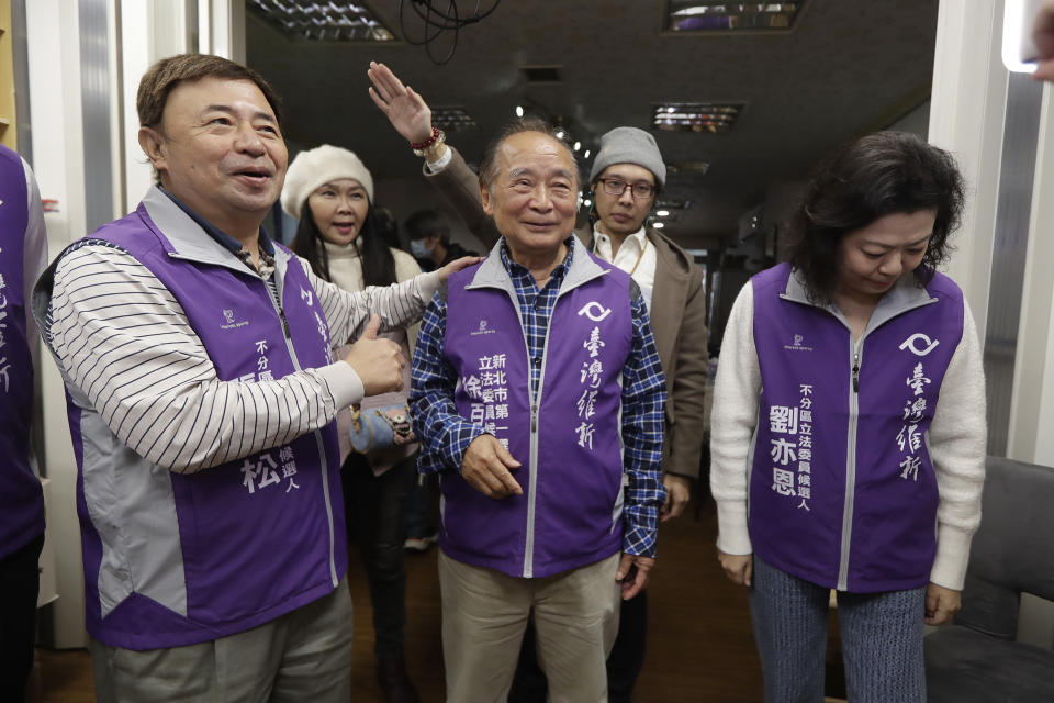 Chui Pak-tai, center, a Taiwanese of Hong Kong descent, cheers with party members during an interview with The Associated Press at his campaign headquarters in New Taipei City, Taiwan, Monday, Dec. 4, 2023. At 72, Chui, a former Hong Kong pro-democracy district councilor who secured Taiwan residency 11 years ago, is running for legislative office. Although he faces long odds, his campaign draws attention to the immigration challenges of the Hong Kong diaspora.(AP Photo/Chiang Ying-ying)