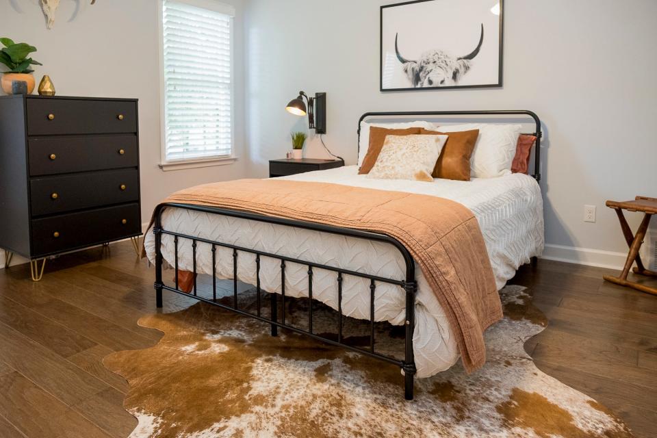 The guest room features a cowhide purchased while the couple was visiting the stockyards in Fort Worth, Texas.