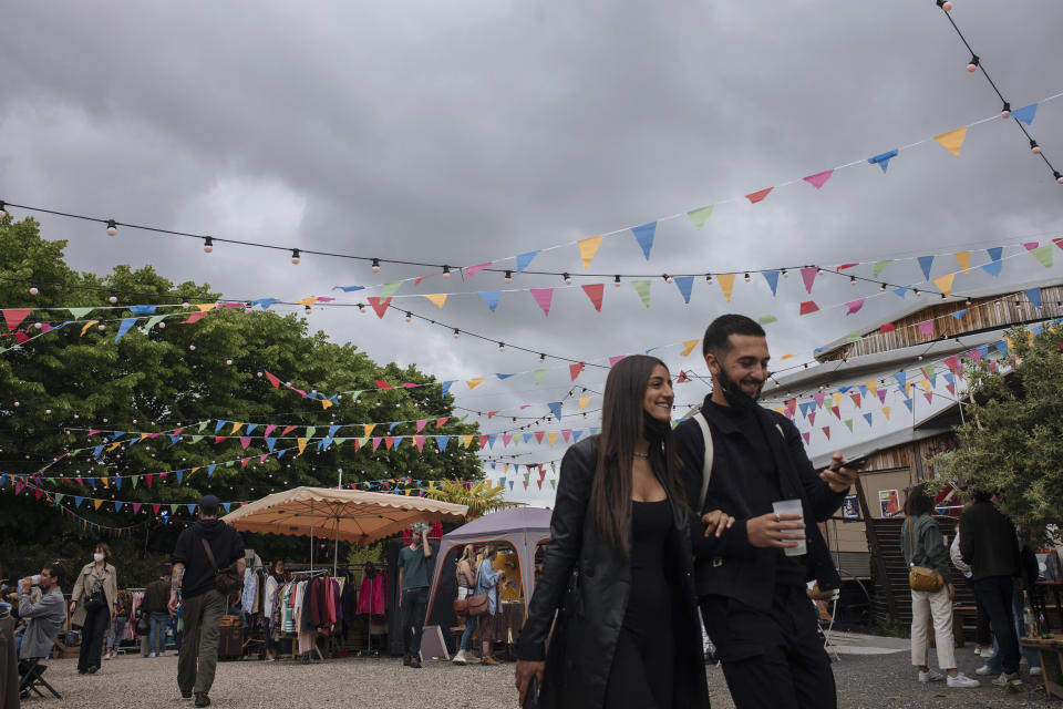 People enjoy the outdoors at a cafe terrace in Paris, France, Saturday, June 5, 2021. (AP Photo/Lewis Joly)