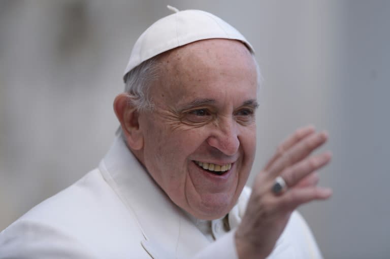 Pope Francis greets the crowd as he arrives for his weekly general audience on February 10, 2016 at St Peter's square