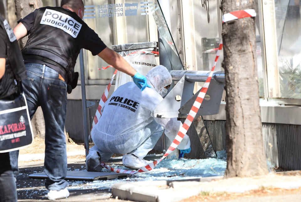 <p>A French criminal police officer gestures as a forensic police officer searches the site following a car crash on Aug. 21, 2017, in the southern Mediterranean city of Marseille. (Photo: Boris Horvat/AFP/Getty Images) </p>