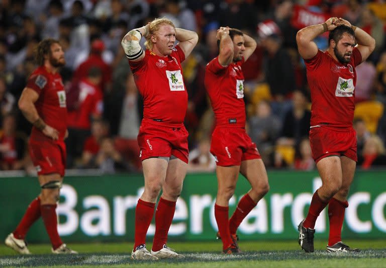 Queensland Reds' players react following the defeat in their Super 15 rugby union game against the Sharks of South Africa, at Suncorp Stadium in Brisbane, on July 21, 2012. The 2013 Super 15 season kicks off this weekend with two all-Australian ties. The Reds play Brumbies in their opener, on Saturday