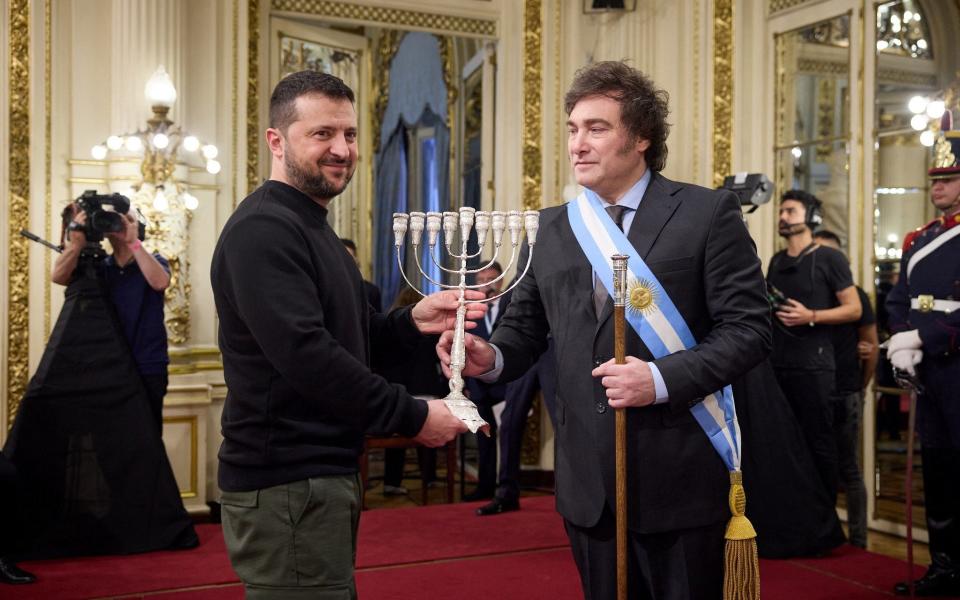 New Argentina president Javier Milei gives a menorah to Volodymyr Zelensky at the presidential palace on Sunday