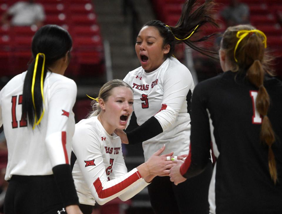 Texas Tech players celebrate a point during the Red Raiders' three-set sweep of Kansas State on Wednesday in a Big 12 volleyball opener at United Supermarkets Arena.