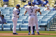 Los Angeles Dodgers shortstop Corey Seager, right, is hugged by Chris Taylor (3) next to manager Dave Roberts, left, after their team's World Series Championship ring ceremony before a baseball game against the Washington Nationals, Friday, April 9, 2021, in Los Angeles. (AP Photo/Marcio Jose Sanchez)