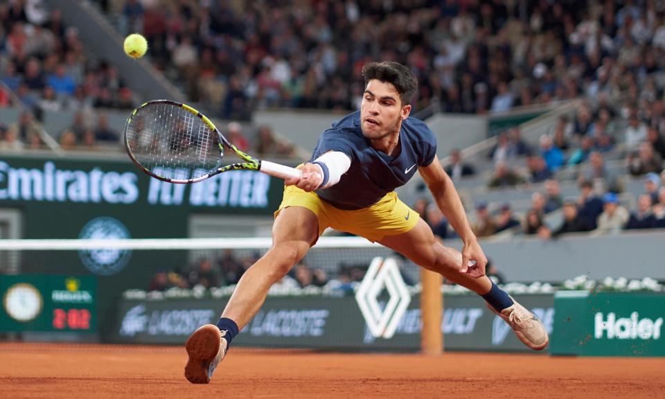 <span>Carlos Alcaraz lunges to retrieve a backhand against Jesper de Jong.</span><span>Photograph: Mateo Villalba/Getty Images</span>