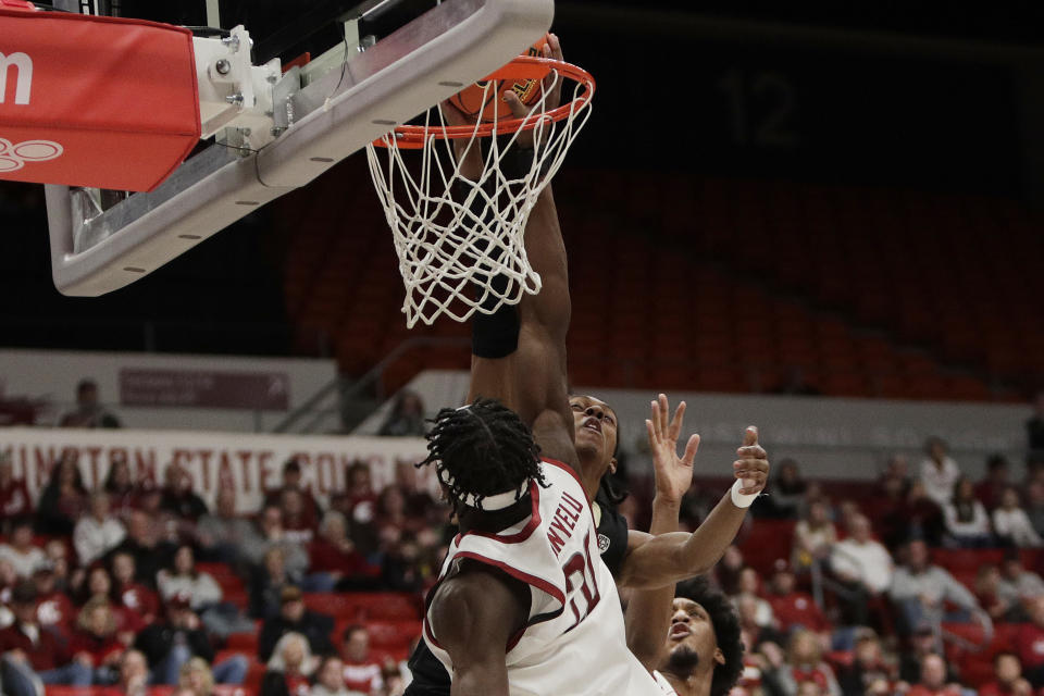 Washington State center Rueben Chinyelu, front, blocks a shot by Colorado forward Cody Williams during the second half of an NCAA college basketball game, Saturday, Jan. 27, 2024, in Pullman, Wash. Washington State won 78-69. (AP Photo/Young Kwak)