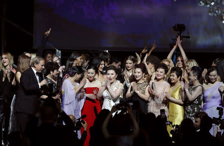 72nd Cannes Film Festival - The amfAR's Cinema Against AIDS 2019 event - Antibes, France, May 23, 2019. A buyer celebrates during the show. REUTERS/Eric Gaillard