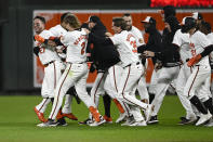 Baltimore Orioles' James McCann (27) celebrates with Gunnar Henderson (2) and others after McCann hit a walk-off single that drove in two runs during the ninth inning of a baseball game against the Kansas City Royals, Wednesday, April 3, 2024, in Baltimore. The Orioles won 4-3. (AP Photo/Nick Wass)