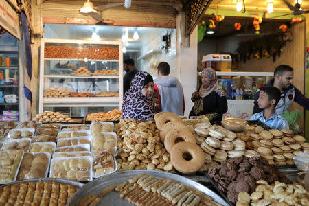 People walk through a market in eastern Mosul, Iraq, April 19, 2017. REUTERS/Marko Djurica