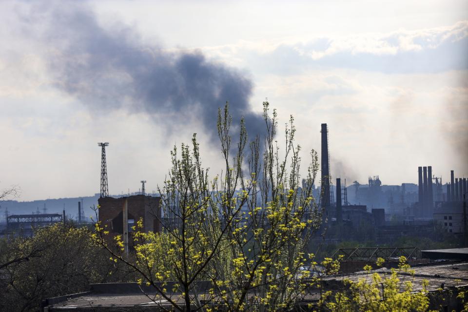 Smoke rises from the Metallurgical Combine Azovstal in Mariupol, in territory under the government of the Donetsk People's Republic, eastern Ukraine, Wednesday, May 4, 2022. (AP Photo/Alexei Alexandrov)