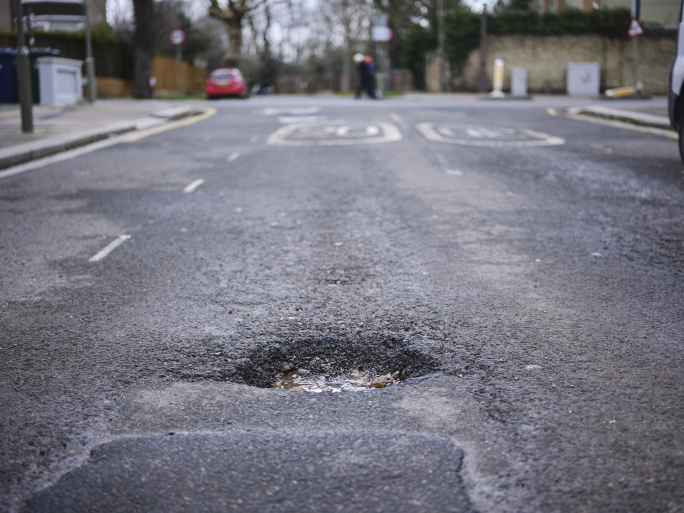 A large pot hole on residential street in North London