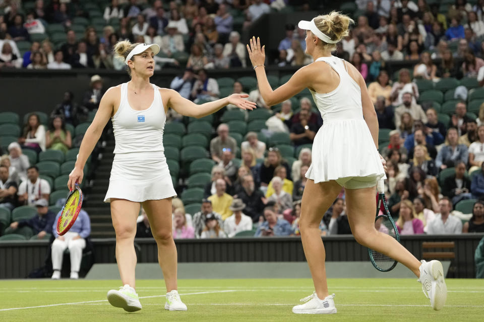 Gabriela Dabrowski, left, of Canada and Erin Routliffe of New Zealand react after winning a point against Katerina Siniakova of the Czech Republic and Taylor Townsend of the United States in the women's doubles final at the Wimbledon tennis championships in London, Saturday, July 13, 2024. (AP Photo/Alberto Pezzali)