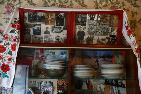 Family photos in wooden frames are seen at a house of 82-year-old Yulia Panchenya in the village of Pogost, Belarus, April 15, 2017. REUTERS/Vasily Fedosenko