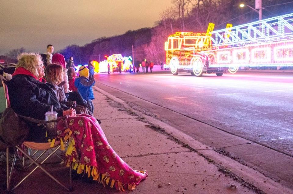 People line up to watch floats pass by on Saturday night during the East Peoria Parade of Lights. The parade celebrated its 30th year along three miles of Washington Street.