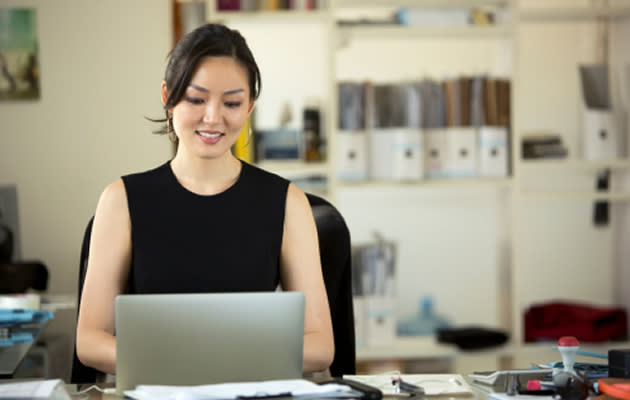 Asian woman working at an office. (Getty Images)